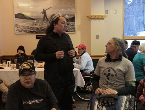 Two men, one of them disabled and in a wheelchair, conversing in a skier's diner at Taos Ski Valley.